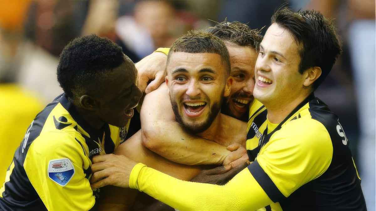 Zakaria Labyad wird von Mitspielern im gelb-schwarzen Trikot von Vitesse umarmt